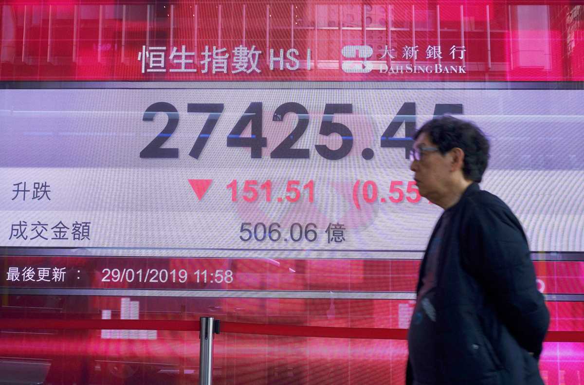 Asian stocks slip on Huawei charges as trade talks loom