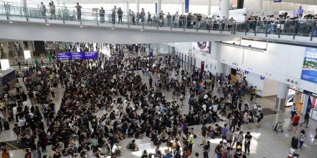 Hong Kong airport grinds to a halt as protests swell