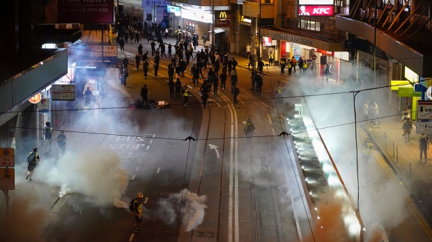 Tear gas engulfs Hong Kong as protesters trash China agency